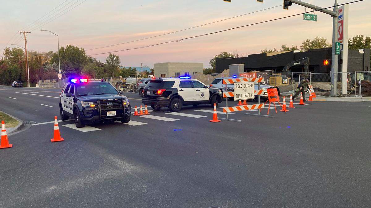 A man is charged with assault in connection with the confrontation with Kennewick police when he was shot after ramming police cars.