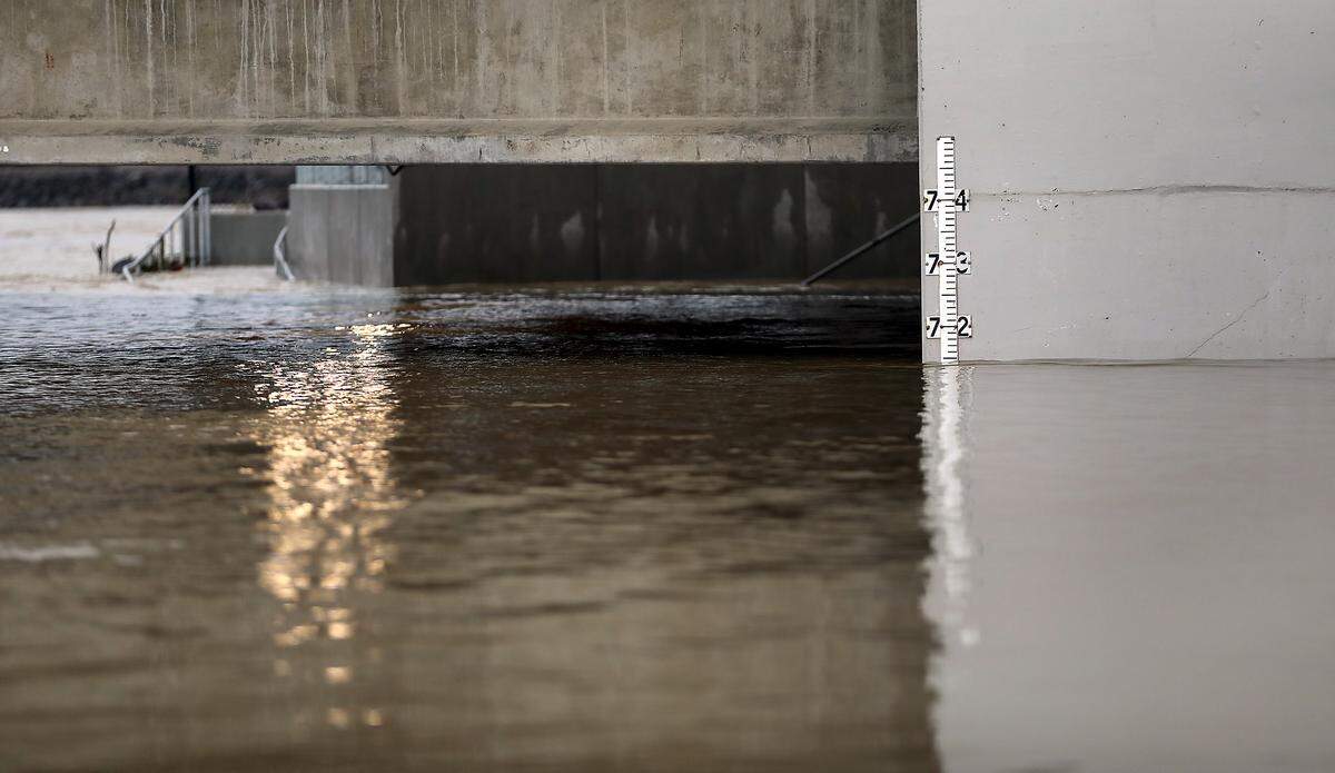 A flood gauge posted near the submerged concrete walkway for the Yakima Gateway Park at the bridge over the Yakima River into West Richland is still submerged as floowaters are receding after peaking over the weekend.