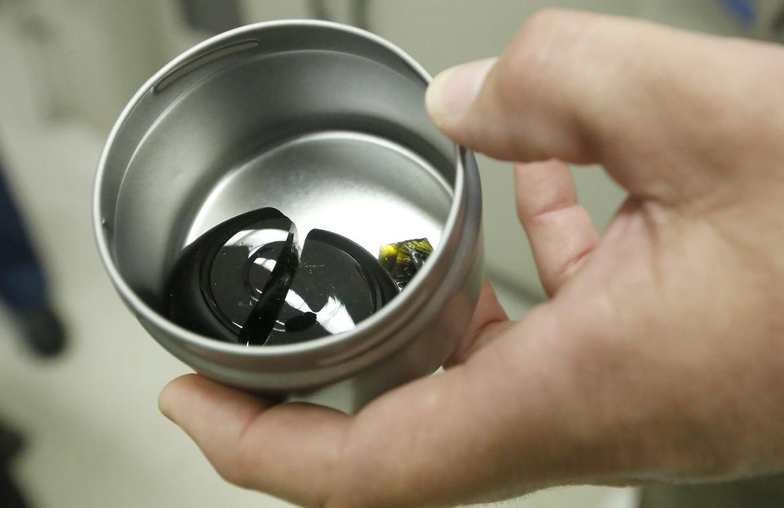 Will Eaton, vitrification task lead at PNNL in Richland, holds a sample of non-radioactive glass from the laboratory-scale melter recently successfully used to vitrify low-activity waste from underground storage tanks at Hanford.