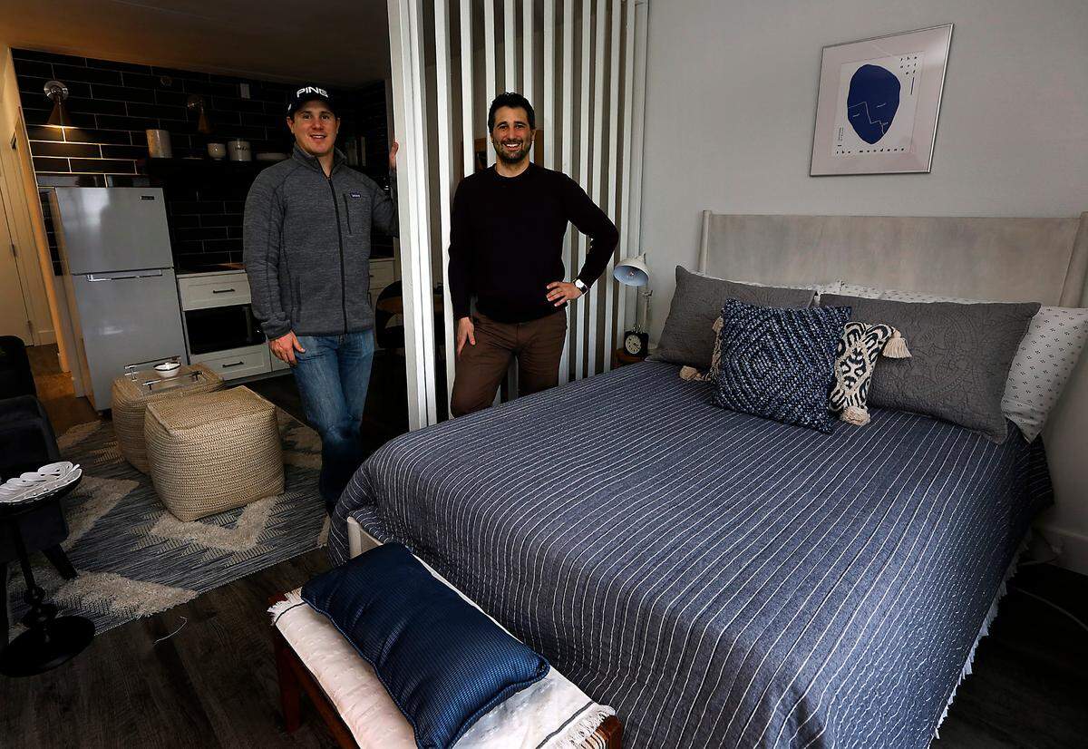 Fortify Holdings co-regional managers Rob Jacobs, left, and his brother, Daniel, stand in a finished model micro apartment inside The Franklin complex in Richland. The company is transforming the former Best Western Plus on George Washington Way into about 200 apartments.