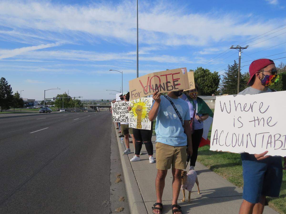 Black Lives Matter protesters stood on Columbia Center Boulevard Saturday in a protest aimed at changing the Regional Special Investigations Unit.