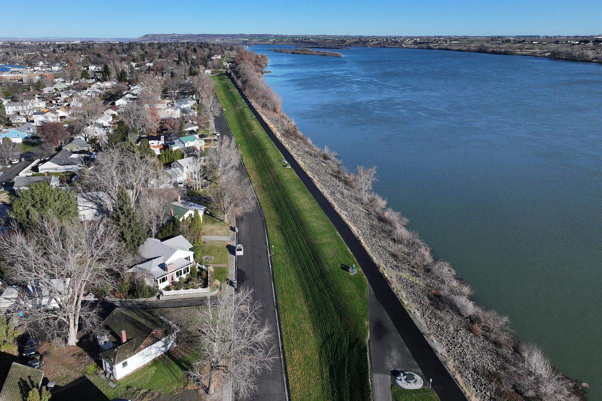 Homes along Hains Avenue near the levee for a walking path in Howard Amon Park along the Columbia River in Richland on a bright sunny day on Dec. 19, 2025.