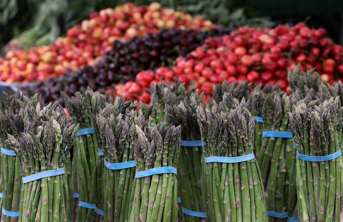 Colorful fresh local fruits and vegetables cover a vendor's tables Friday morning for the opening of the Richland Farmers Market.