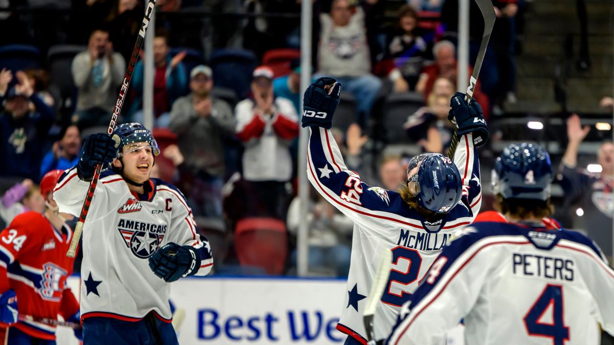 Tri-City Americans captain Marc Lajoie, left, and teammate Deagan McMillan celebrate on the ice during 2022-23 season. Teammate Ethan Peters (4) also joins the play.