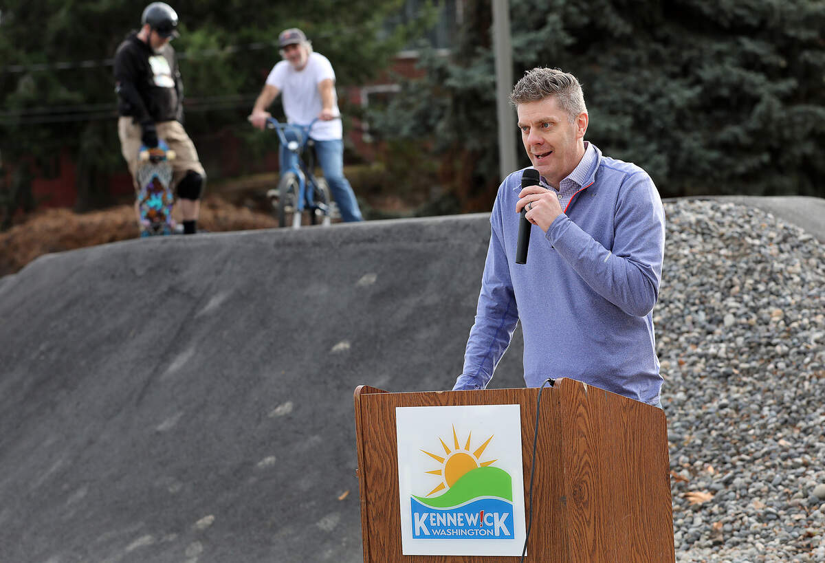 Kennewick's recreation manager Brandon Lange speaks during Thursday’s grand opening for the new Vancouver Park pump track. The new park amenity offers a roller-coaster-like ride to bicyclists and skateboarders.