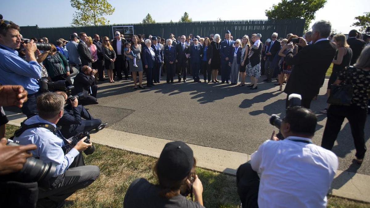 Members of the media watch as family and friends of Elaine Danforth Harmon arrive for burial services at Arlington National Cemetery in Virginia. It took an act of Congress, but Harmon was finally laid to rest on at Arlington National Cemetery; she died last year at age 95. She was one of the Women Airforce Service Pilots who flew military aircraft on noncombat missions during World War II so that men were freed up for combat.