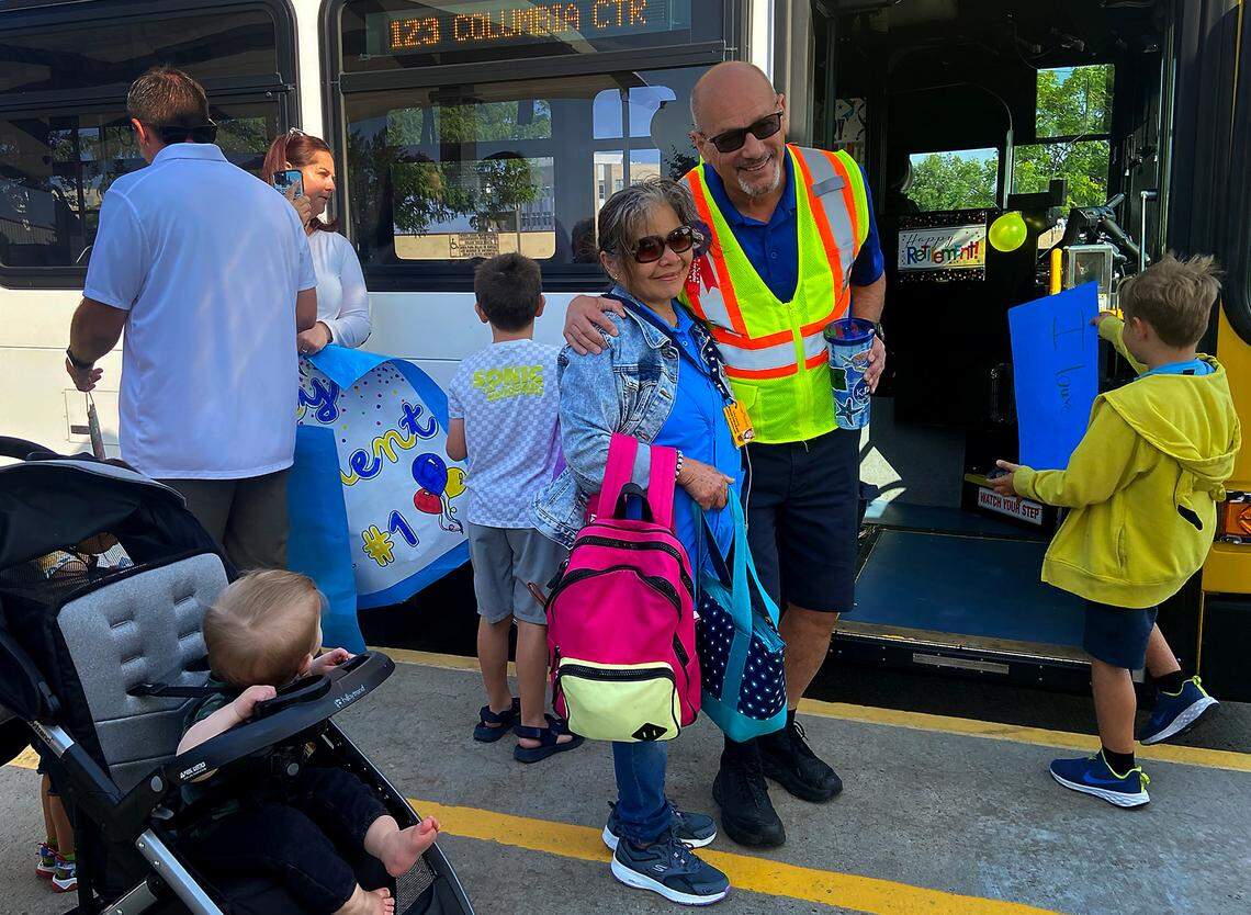 Longtime Ben Franklin Transit driver, Steven McMurray, takes a picture with a family member before driving his last route.