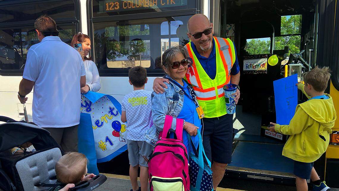 Longtime Ben Franklin Transit driver, Steven McMurray, takes a picture with a family member before driving his last route