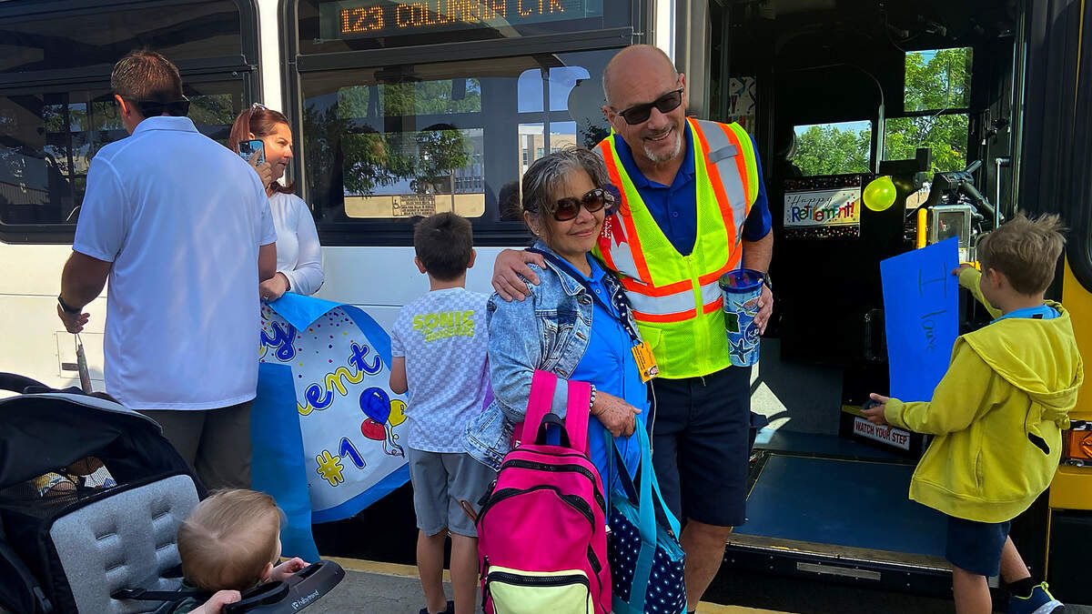Longtime Ben Franklin Transit driver, Steven McMurray, takes a picture with a family member before driving his last route