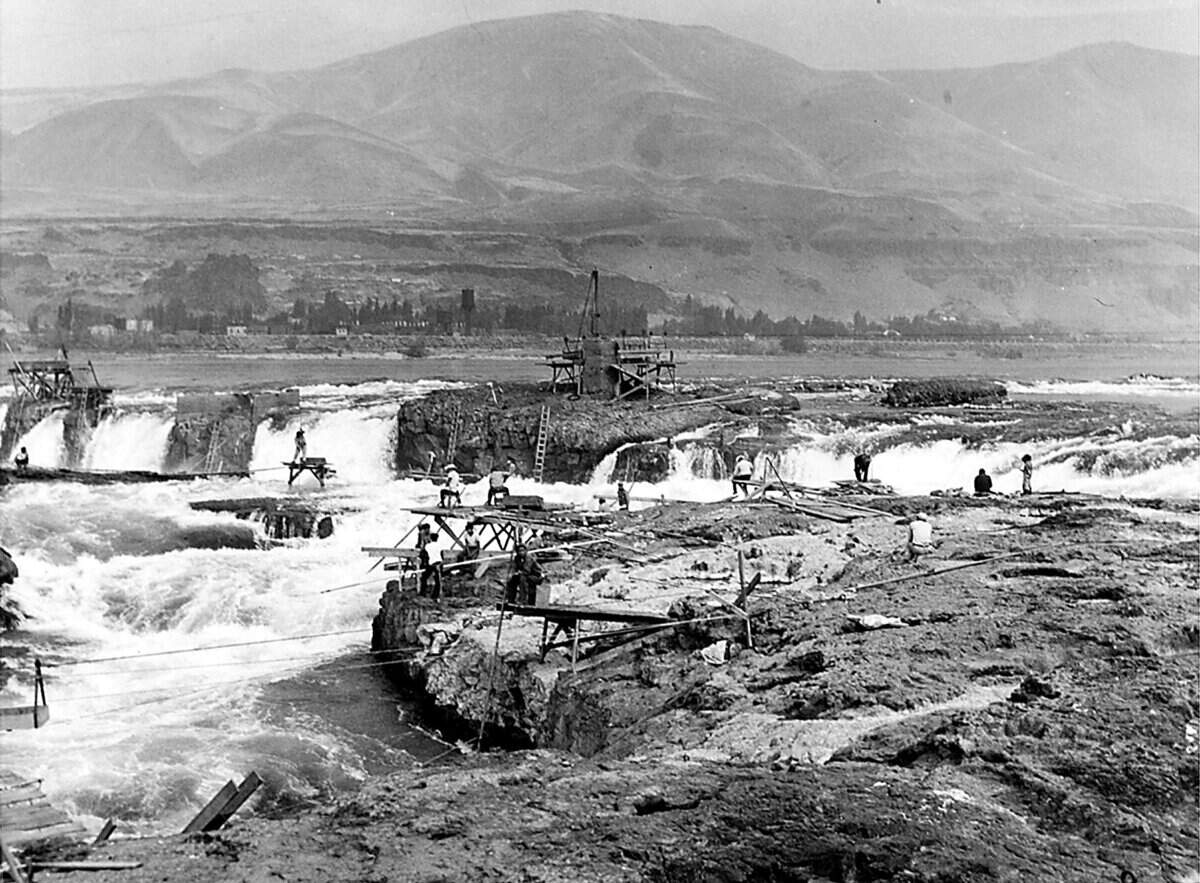 Anglers work from a series of platforms to dip their nets in the Columbia River for salmon at Celilo Falls on the Columbia River in 1940.