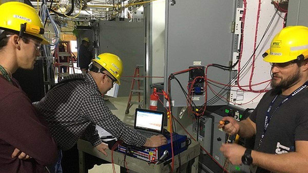 Members of a startup team at the Hanford vitrification plant test the control system in the Analytical Laboratory.