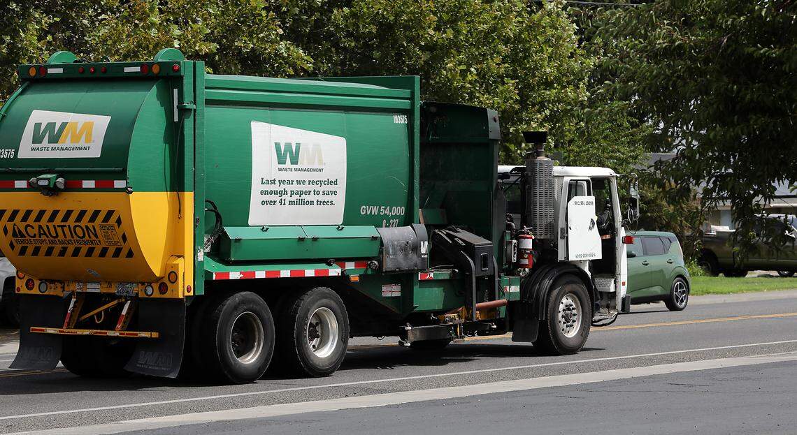 A Waste Management truck recently travels on West Fourth Avenue in Kennewick. 