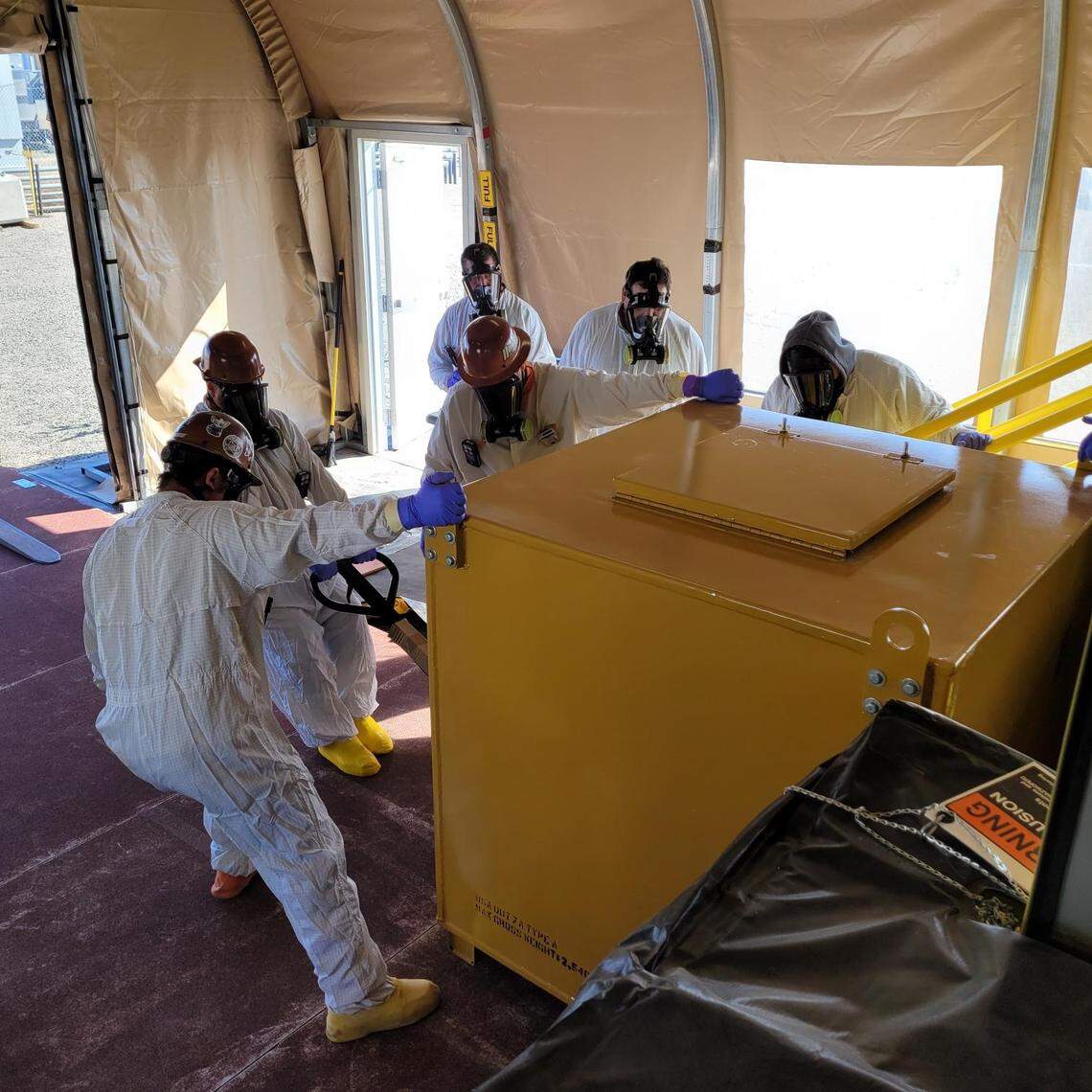 Hanford workers remove a shipping container filled with liquid, low activity radioactive waste from the SY Tank Farm at Hanford to be shipped out-of-state for grouting and disposal in the Test Bed Initiative, a demonstration project.