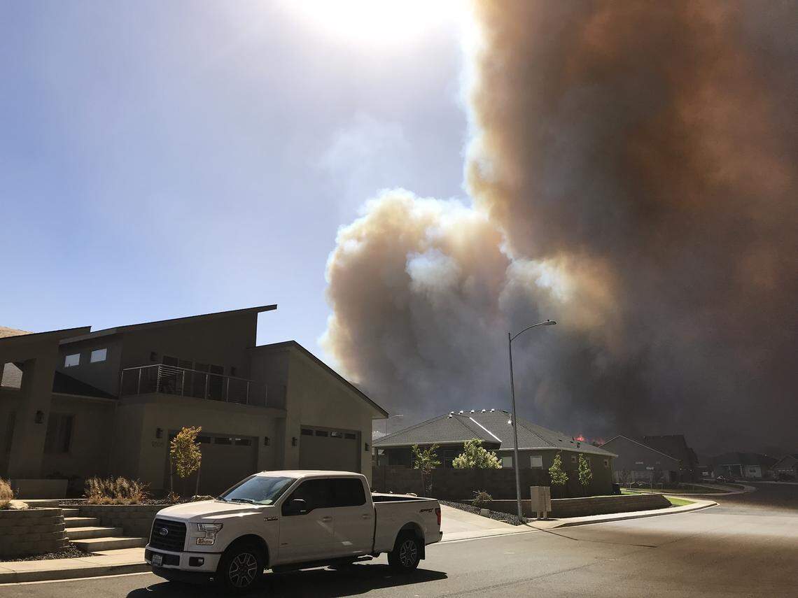 Smoke from the Bofer Canyon Fire darkened the skies and threaten south Kennewick neighborhoods on Saturday.