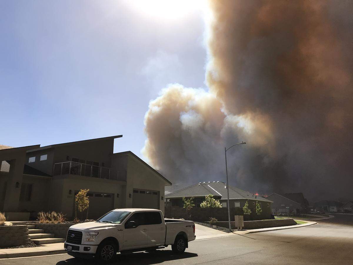 Smoke from the Bofer Canyon Fire darkened the skies and threaten south Kennewick neighborhoods on Saturday.