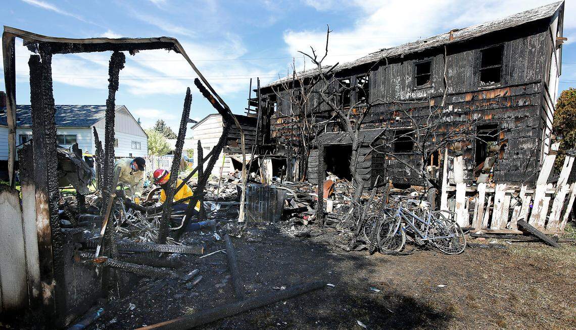 Firefighter Josh Jordon, left, and Capt. Josh Patterson of the Richland Fire Department search for clues to the cause of a fire that heavily damaged a vacant home in July 2020.