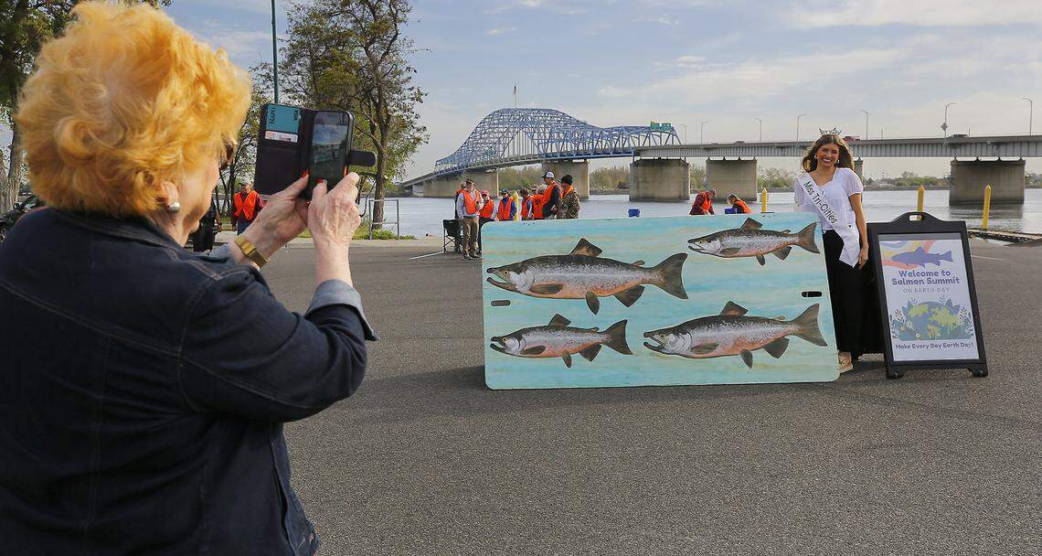 Miss Tri-Cities Julia Henry poses for a photo being taken by Dot Stewart, executive director and pageant director, Tuesday morning  just prior to the start of two-day Salmon Summit in Kennewick’s Columbia Park.