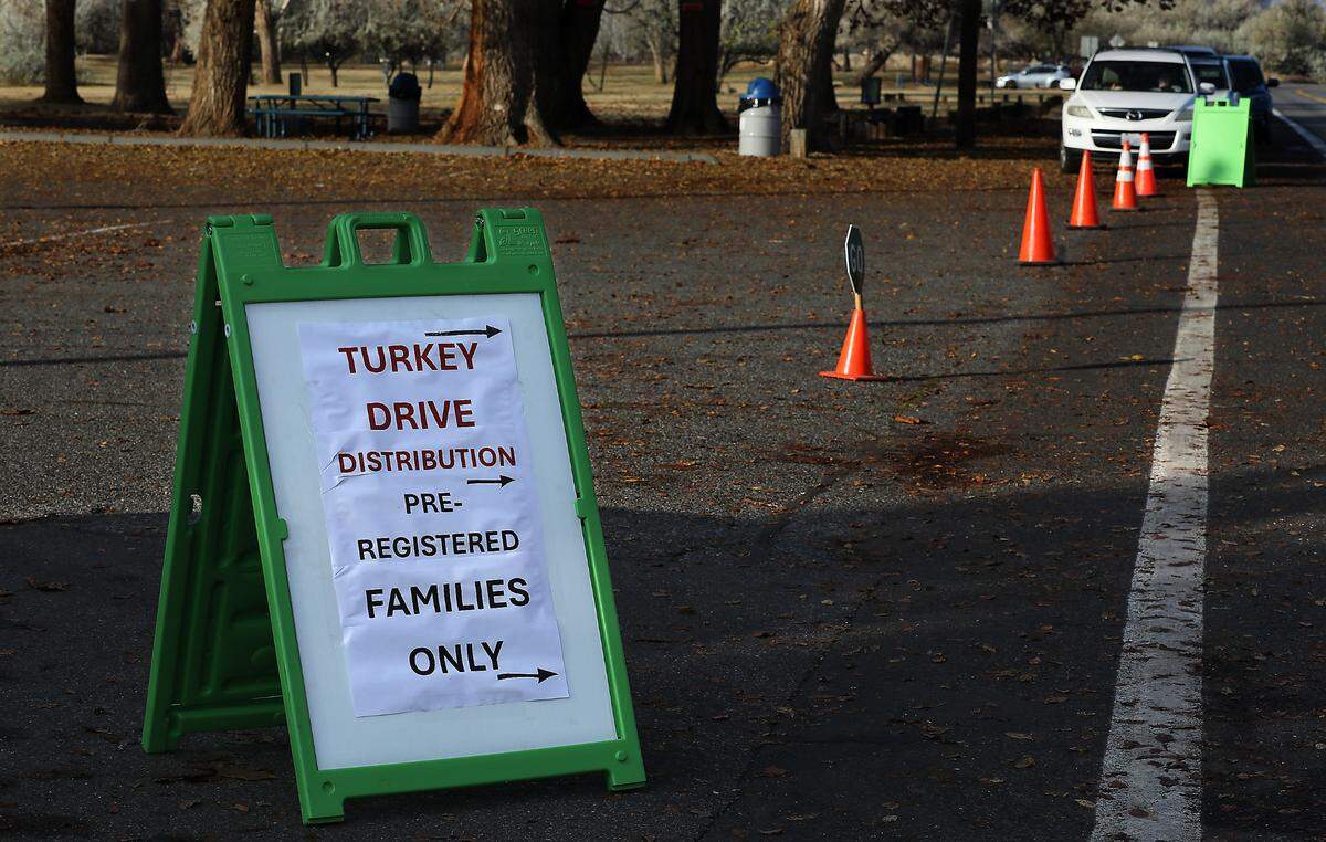 Vehicles line up in Columbia Park for the start of Tuesday’s 2nd Harvest Turkey Drive turkey dinner distribution.