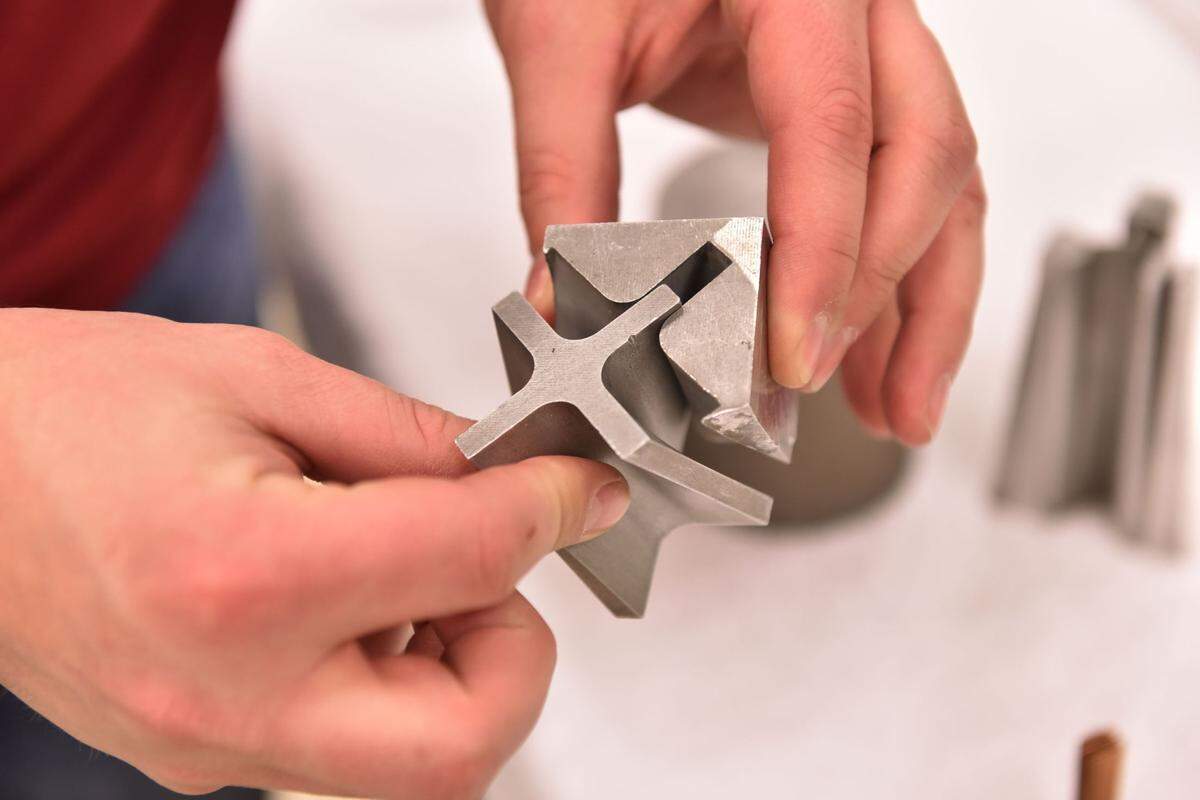 A custom metal piece made by a PNNL machinist is just one example of the many ways skilled labor at PNNL support researchers with a broad array of science and technology activities.