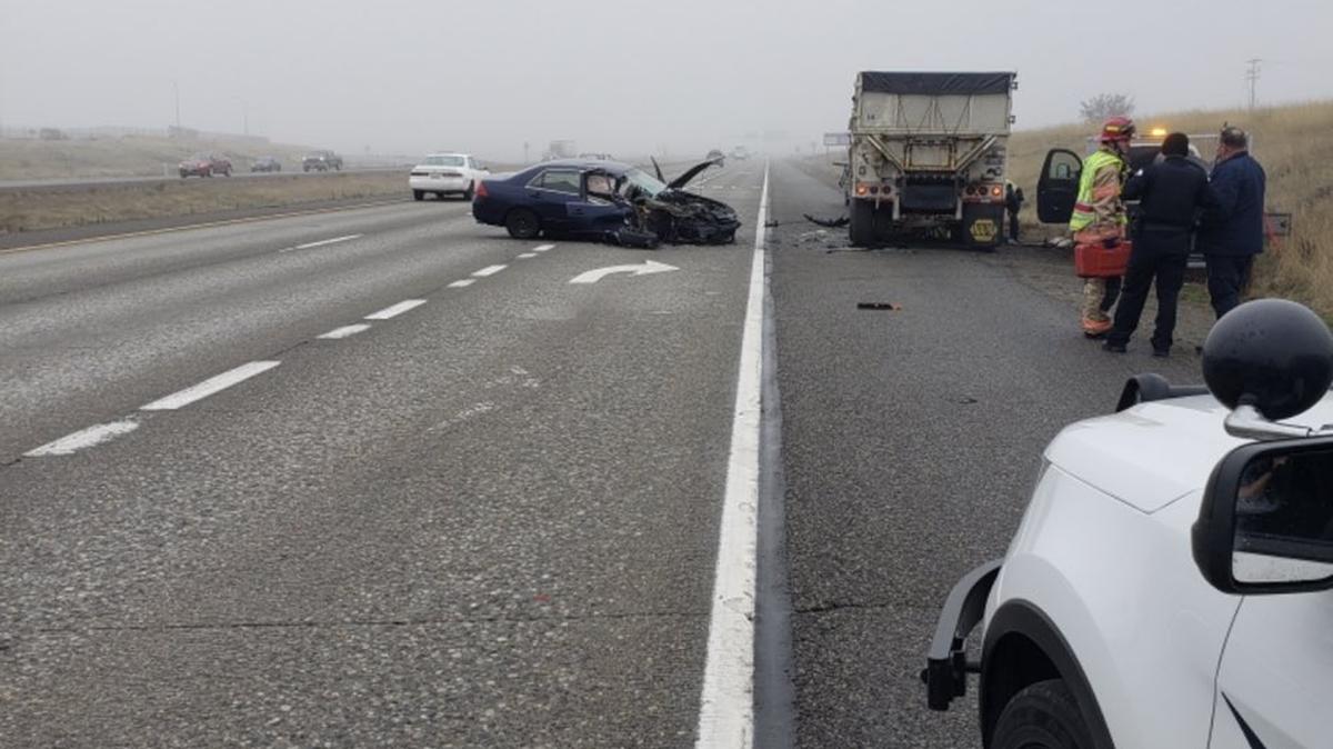 A Les Schwab employee was working underneath the semi when the car slammed into it.