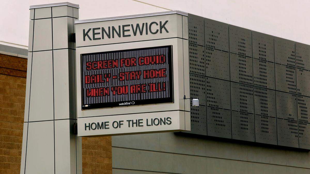 The electronic reader board at Kennewick High School displays a COVID safety message for students, staff and passersby on South Dayton Street and West Sixth Avenue in downtown Kennewick.
