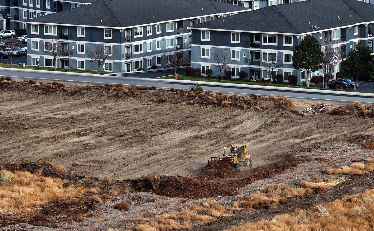 A large bulldozer works preparing the 30-acre Richland site behind Grocery Outlet and Target, for the new Costco store.