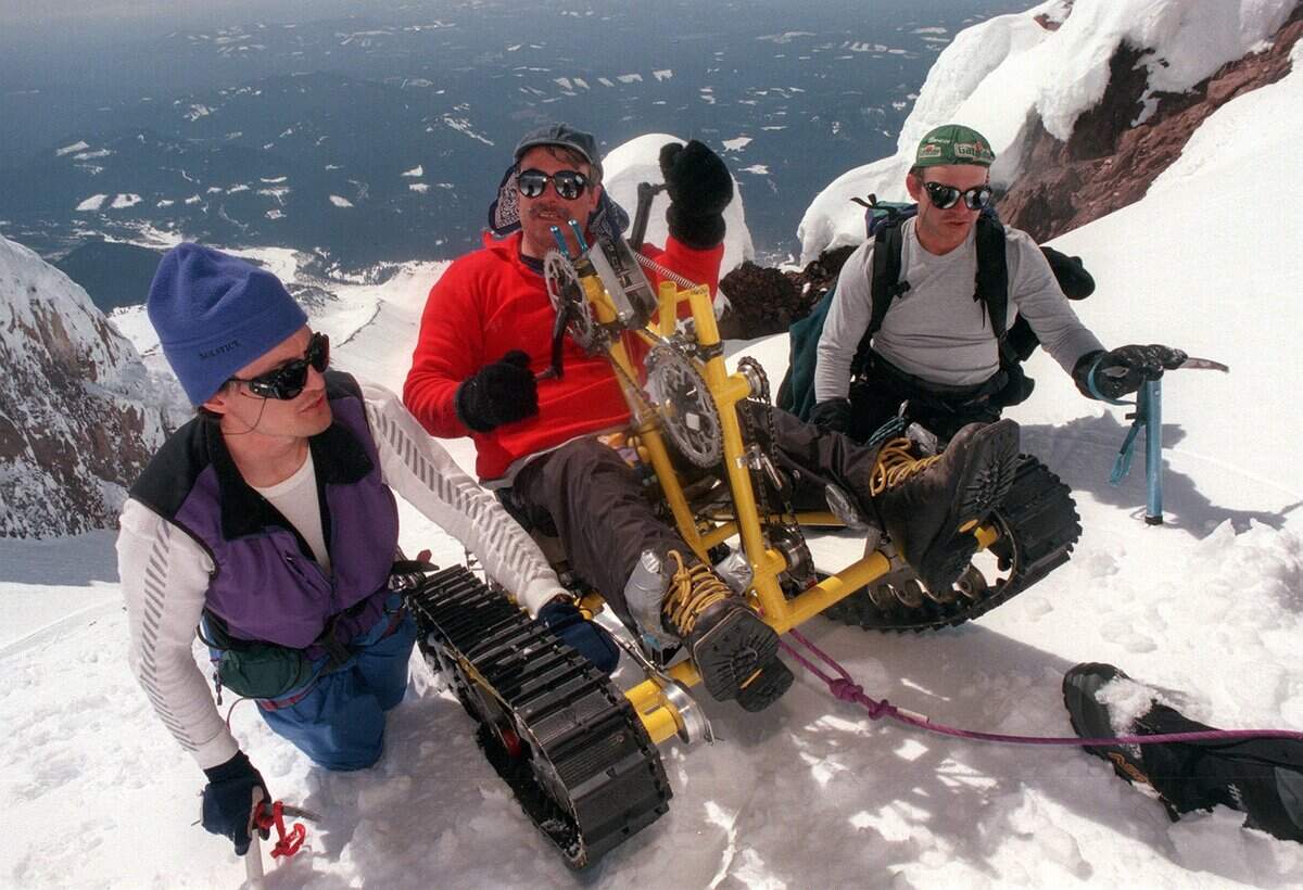 Carl Jarvis, left, and Mike Poole steady Pete Rieke as they approach the summit of Mount Hood in Oregon. Although team members often spotted Rieke on the steeper portions of the mountain, Pete’s arms provided all the energy that propelled him and his specially designed “snow pod” up the mountain.