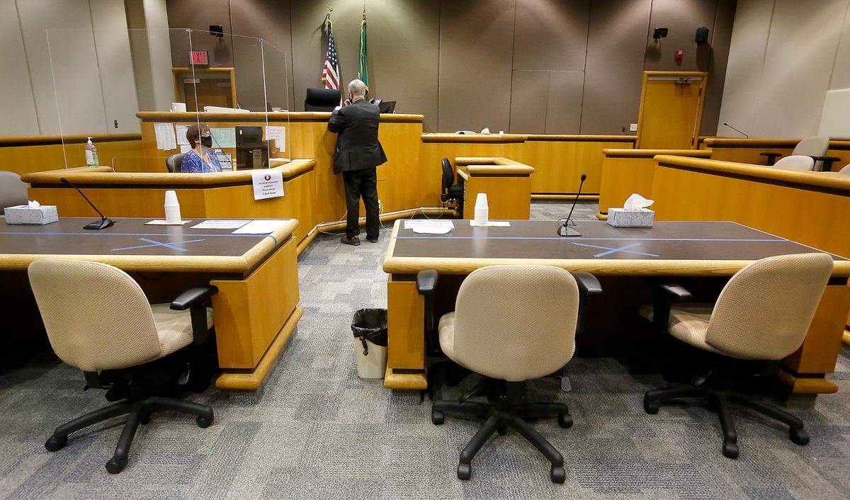 The clerk and bailiff are the only people in a Benton County Superior Court courtroom for a telephonic hearing in the divorce case between Benton County Sheriff Jerry Hatcher and his wife, Monica.