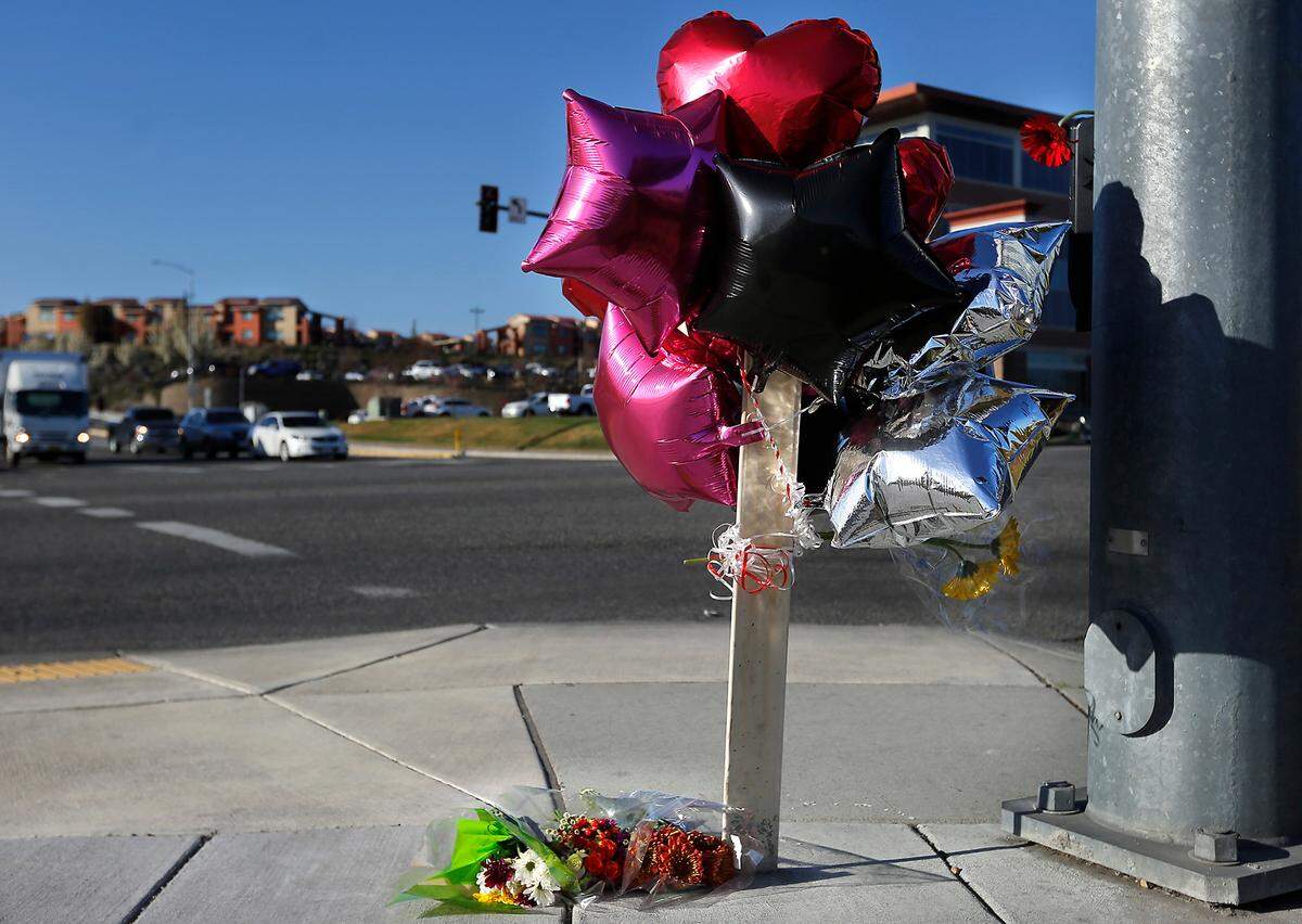 A memorial of balloons and flowers pays tribute to fatal traffic collision victims Tressica Garza and Wayne Judd at North Steptoe Street and West Gage Boulevard in Kennewick. Police say they were driving east on Gage when Mariana Souza ran a red light and slammed into their SUV, killing them instantly.