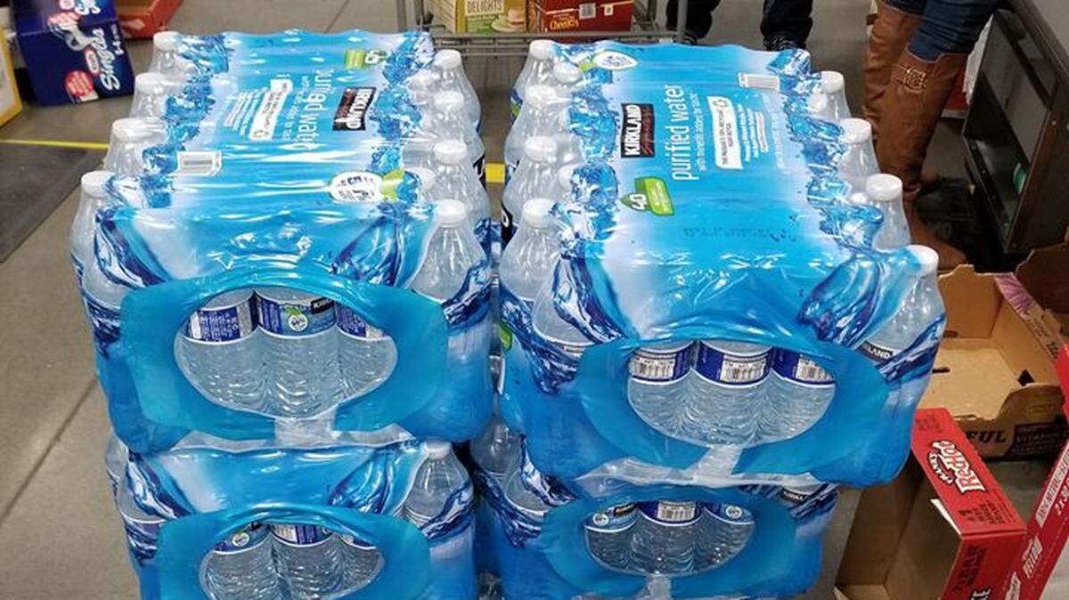 A Costco cart loaded with cases of bottled water before the Kennewick store ran out. The cart was being pushed by a man who said his wife had already bought the limit of six cases of Kirkland purified water that morning and he had returned for more.