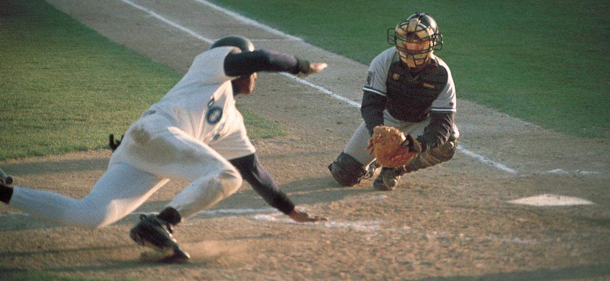 Grays Harbor catcher Mike Hubel stretches to tag a diving Corey Paul of Tri-Cities for the final out of the second inning in a 1996 game.