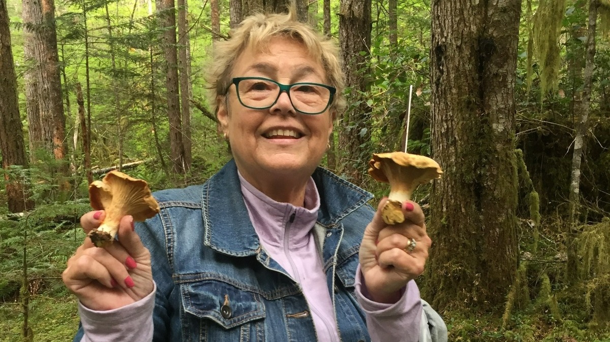 A pair of golden chanterelles brings a smile to Nancy Dauble’s face.