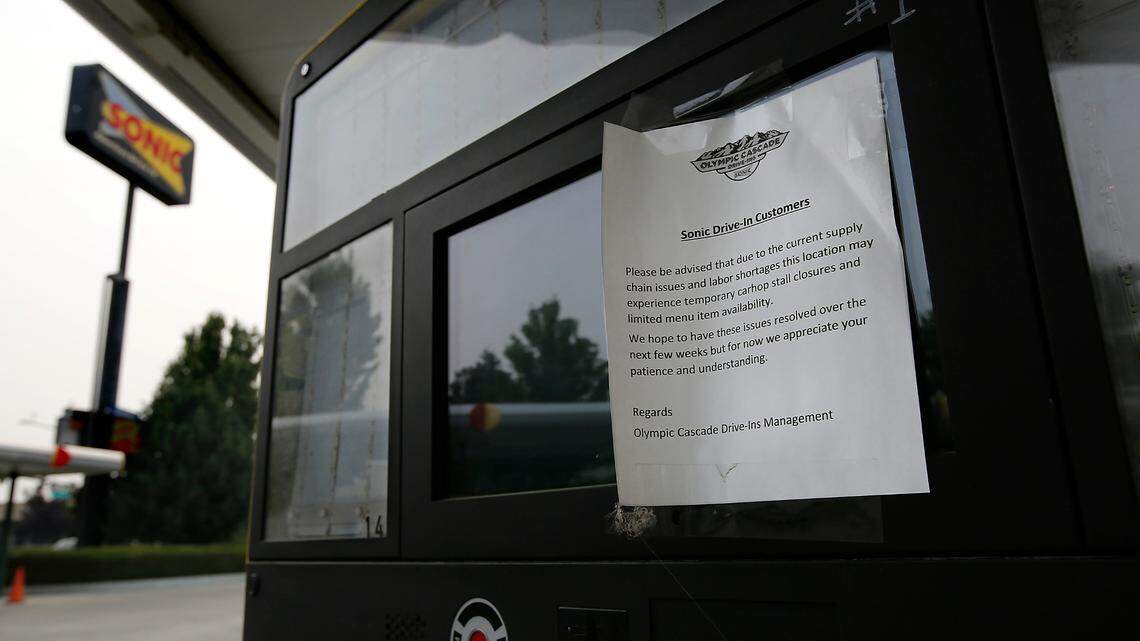 Undated typed notes posted on the Sonic Drive-In menu boards advise customers of supply chain issues and labor shortages that are impacting carhop service and menu item availability at the business off Gage Boulevard in Kennewick.