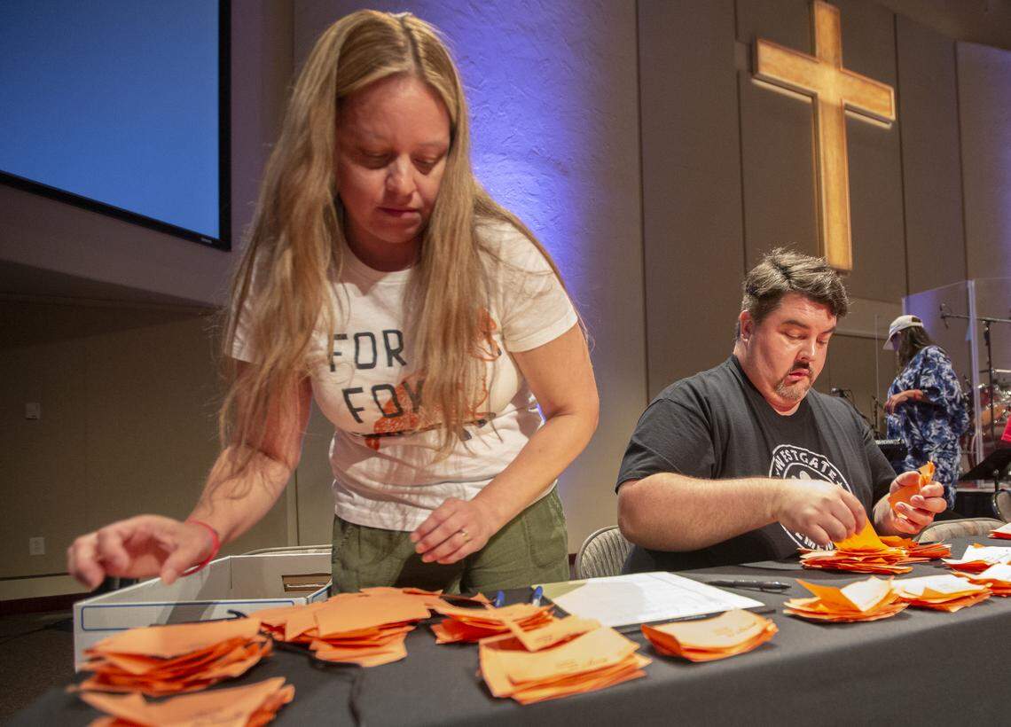 Coco Mayo-Shjerven, left, and Bradley Barwell help count votes Friday at South Hills Church to end the Kennewick teacher strike.