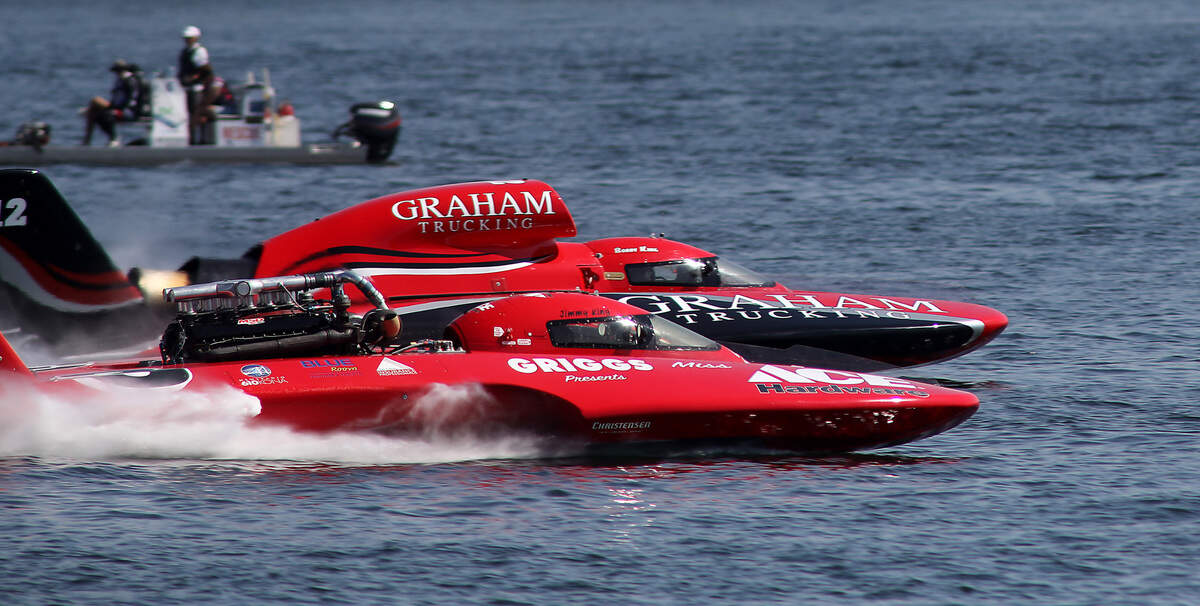 Rookie driver Bobby King in the U-12 Graham Trucking and his father, Jimmy King, in the U-3 Grigg’s present Miss Ace Hardware are side-by-side on the Columbia River during a 2023 testing session for the Columbia Cup unlimited hydroplane race.