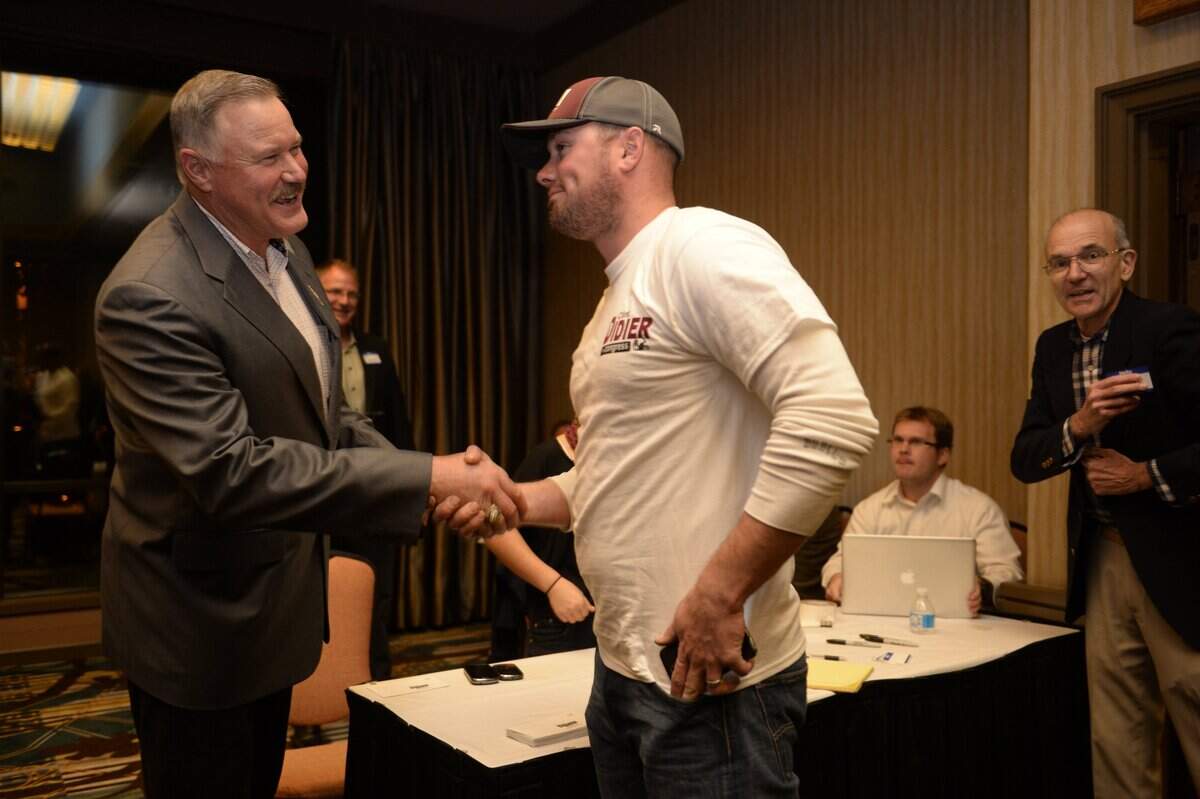Clint Didier, candidate for Congress in 2014, shakes hands with his son Travis Didier of Pasco during an election night party at the Red Lion Inn in Pasco.