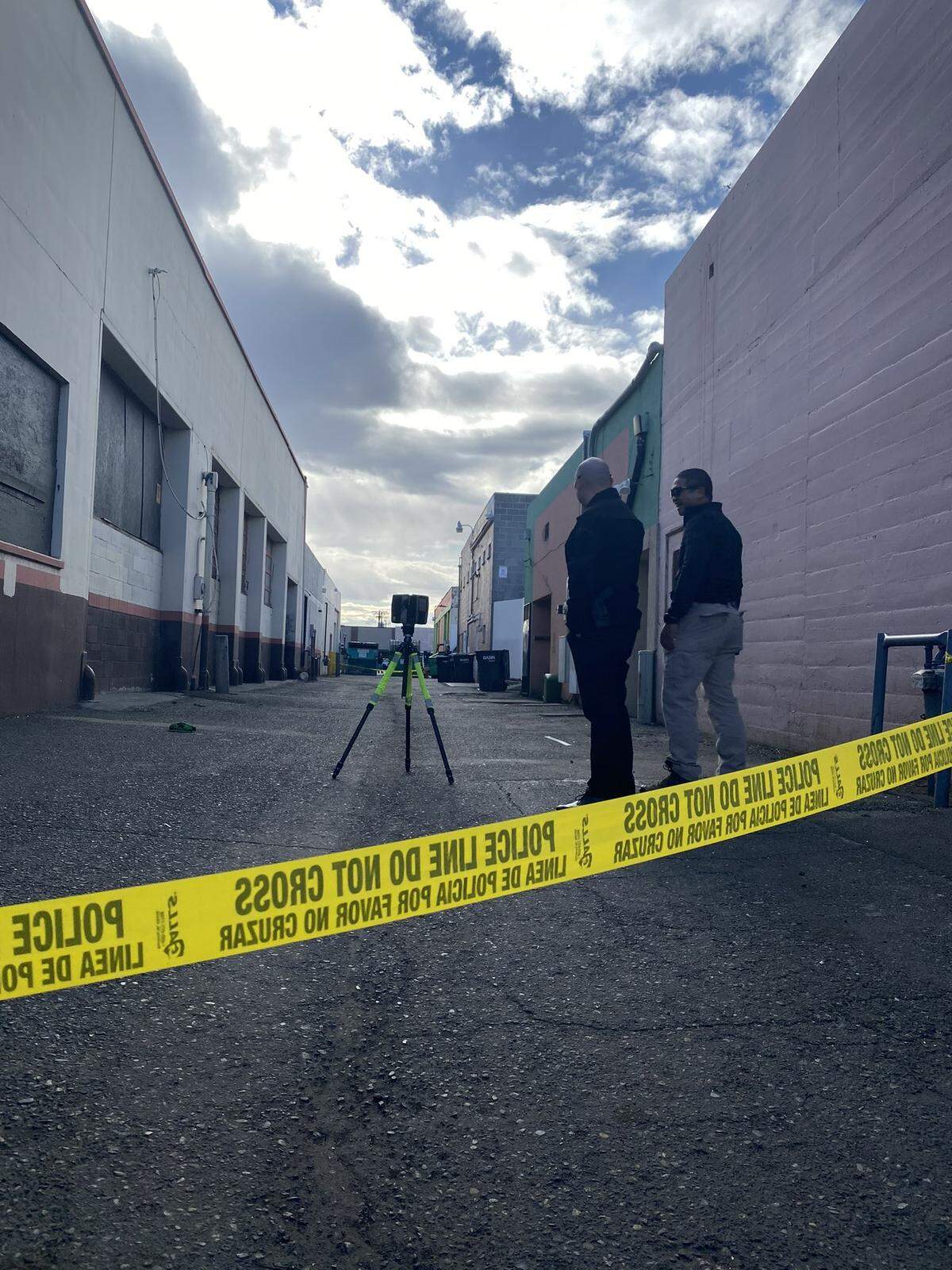 Pasco police take measurements in a downtown alley where a man was shot in the leg on Tuesday afternoon.