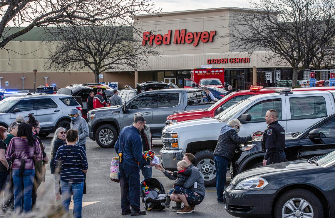 Police talk with employees and customers who were inside the Richland Fred Meyer when Instacart shopper Justin Krumbah was shot and killed.
