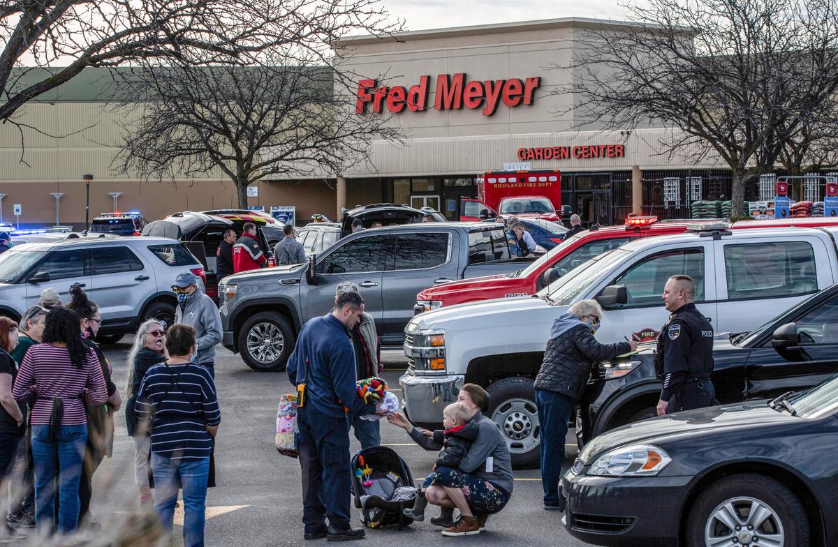 Police talk with employees and customers who were inside the Richland Fred Meyer Monday when Instacart shopper Justin Krumbah was shot and killed.