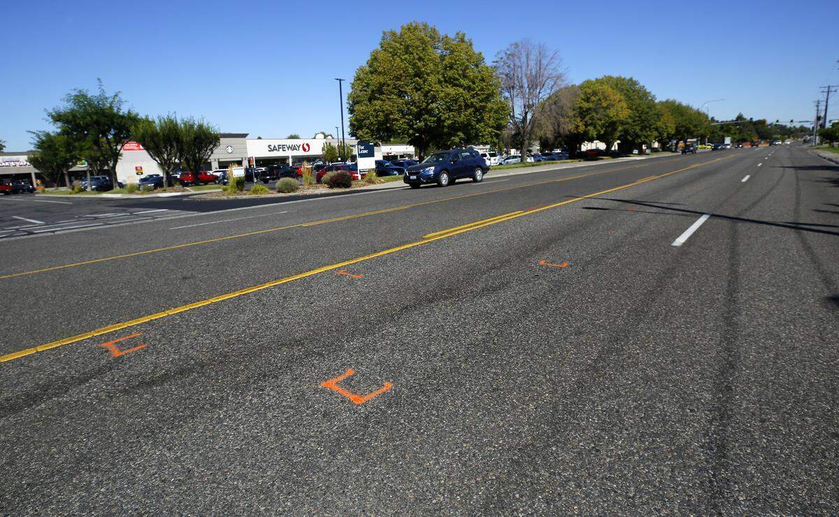 Police investigative paint marks the asphalt on the 1800 block of George Washington Way where a 66-year-old man was hit and killed by a car Sunday in Richland.