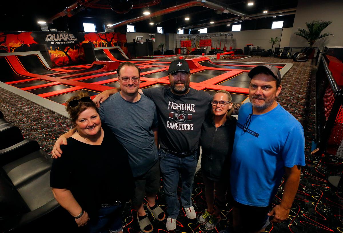 Business partners Merry Holmes, Paul Knabe, Mike Detrick and Tracy and Donavan Nickerson, from left, wil extend their Quake family entertainment center brand to Columbia Center, where they will open an arcade in September.