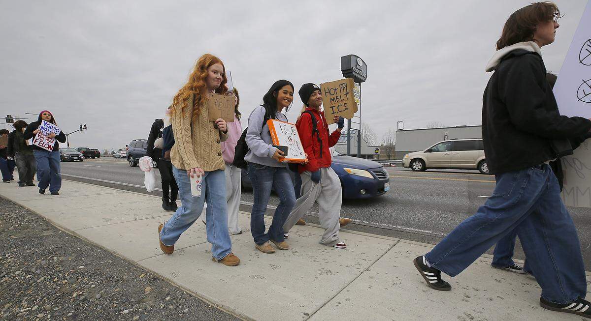 Dozens of high school students from Pasco walk eastbound on West Court Street in Pasco Friday afternoon during a march to protest ICE and the immigration enforcement.