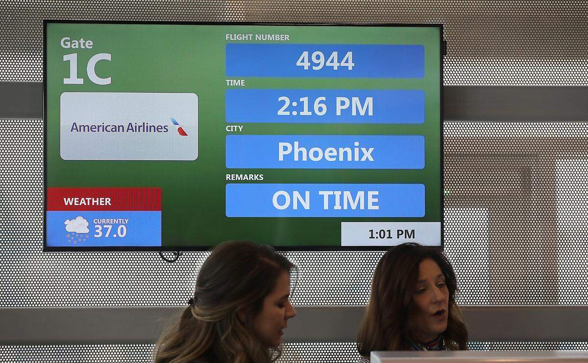 Electronic gate sign shows the departure time for the inaugural American Airlines flight to Pasco.