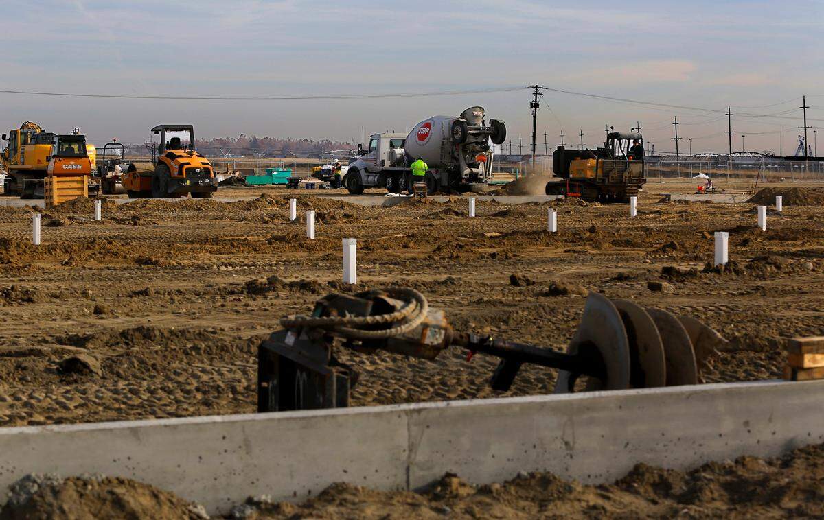 Heavy equipment works on pouring concrete at the Local Bounti greenhouse construction site on a parcel of land just south of A Street between the intersections Elm Street and Oregon Avenue in Pasco.