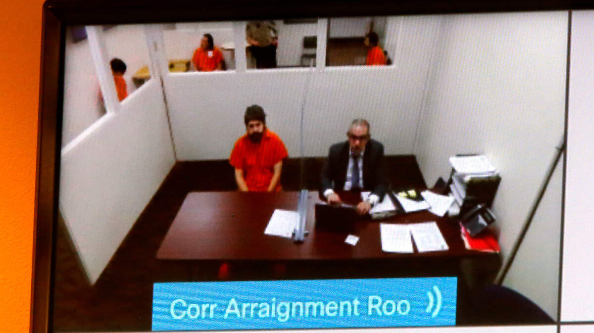 Murder supect Joshua D. Davis, left, appears for a hearing in April 2022 in Franklin County Superior Court via a video link in the fatally stabbing Pasco school bus driver, Richard “Dick” Lenhart.