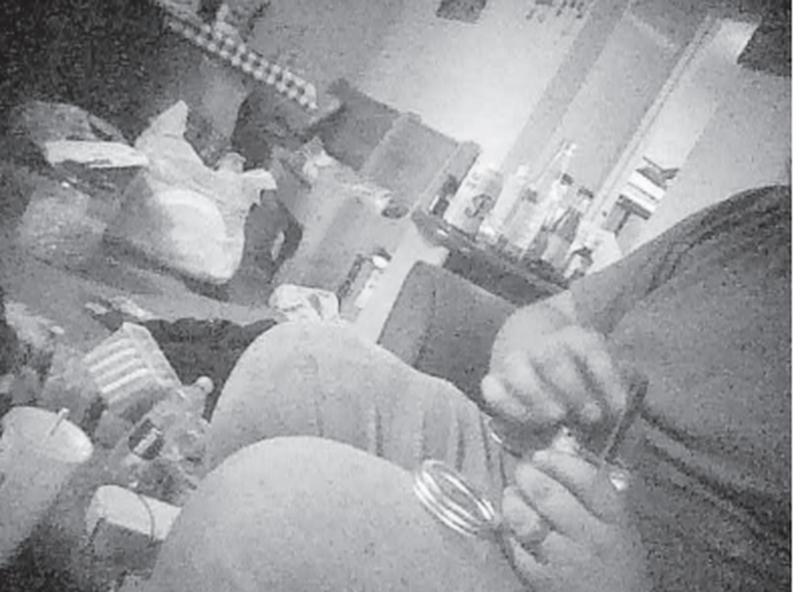 Shown is a screenshot from a video taken by an FBI confidential informant that federal court documents say shows Daniel James Anderson, of Kennewick, inserting a charge into an explosive device he made.