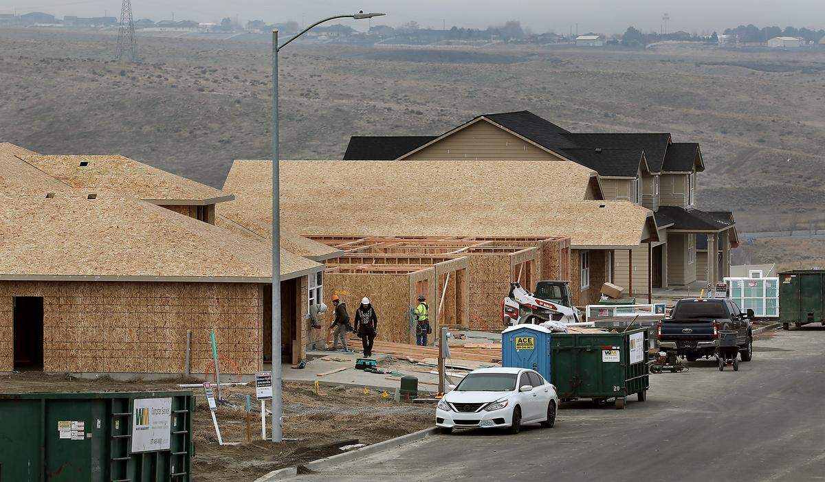 Construction crews work on several homes being built on West 24th Avenue near South Wilson Street in the Sherman Heights development by Hayden Homes in the southridge area of Kennewick. 