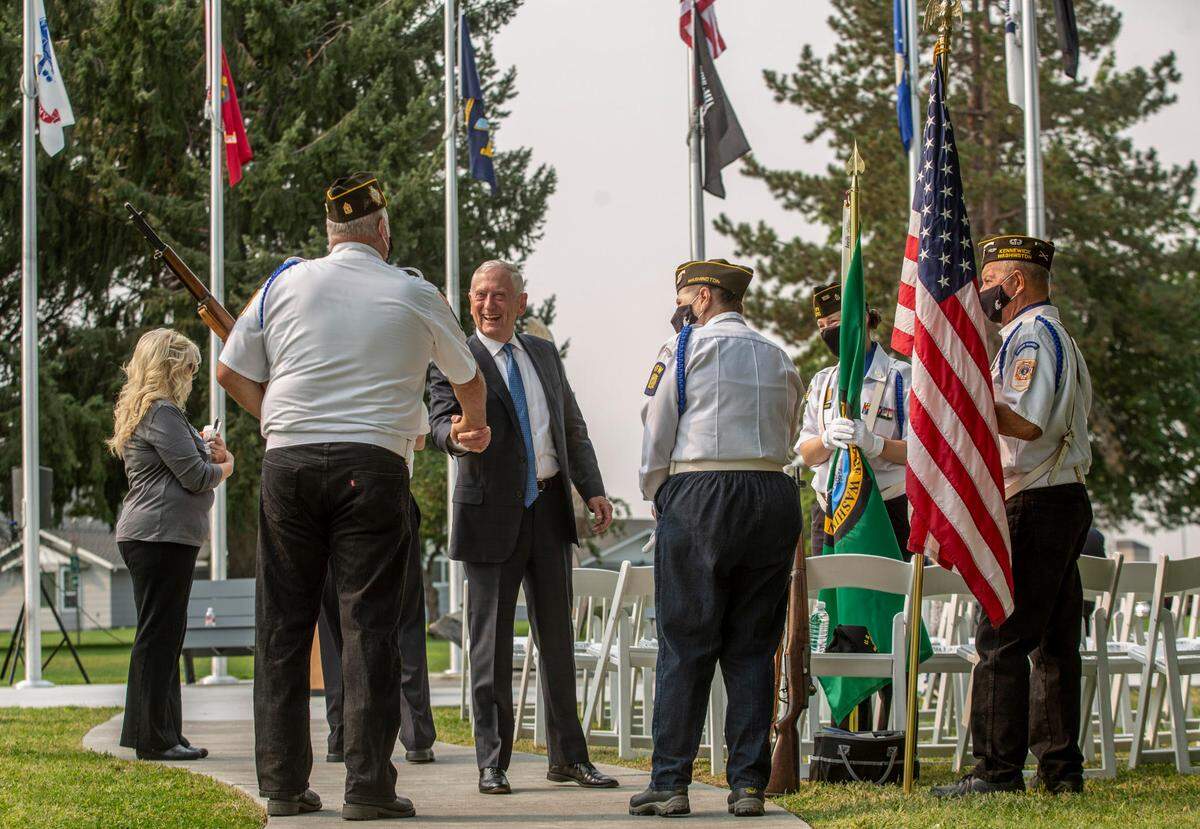 Retired Gen. James Mattis, former secretary of defense, greets members of a honor guard unit before a 2021 ceremony at the Washington State University Tri-Cities campus.