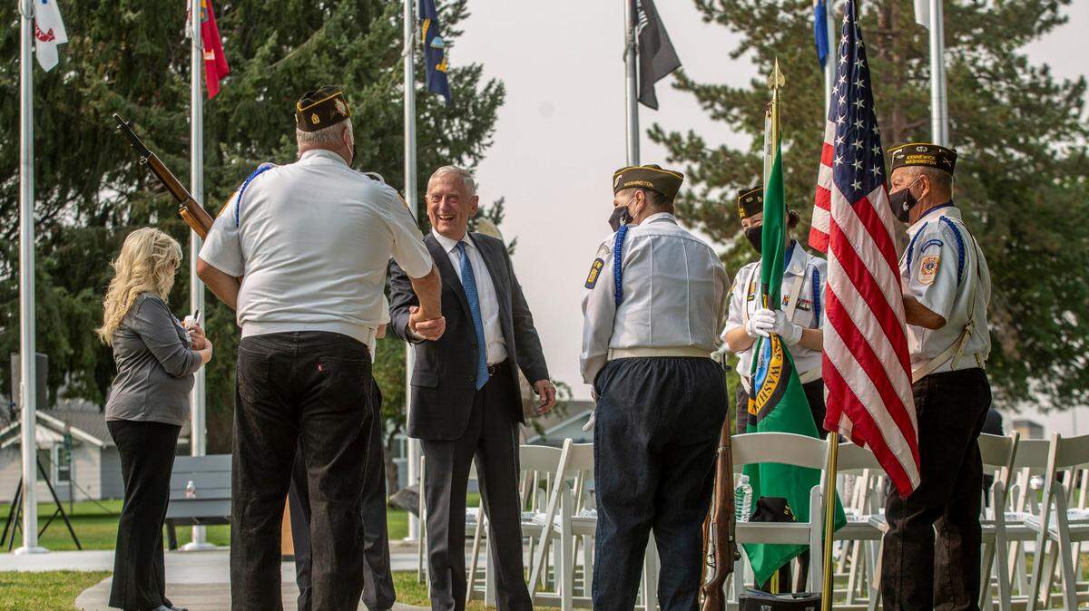 Retired Gen. James Mattis, former secretary of defense, greets members of a honor guard unit before a 2021 ceremony at the Washington State University Tri-Cities campus.