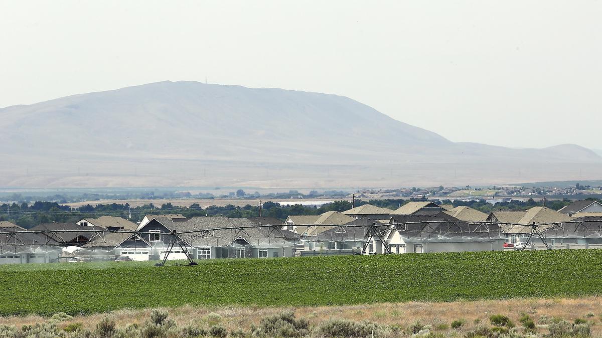 The Pasco School District plans to build a future high school on this farmland near new housing developments in an unincorporated area west of Pasco.  Six years after the school district began assessing a $4,700 impact fee on new homes, more than $1.1 million remains uncollected.